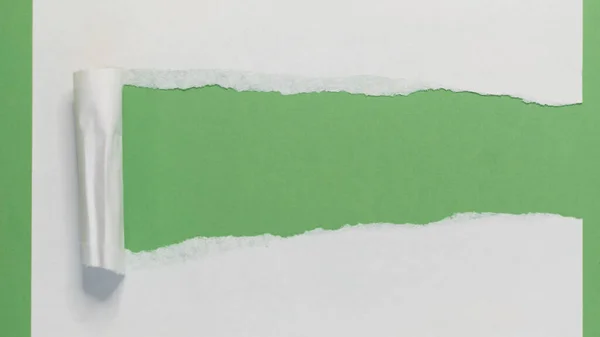 Torn Paper Strip on Green. Torn Paper showing green background isolated on a white background — Stock Photo, Image