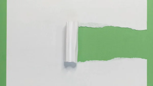Torn Paper Strip on Green. Torn Paper showing green background isolated on a white background — Stock Photo, Image