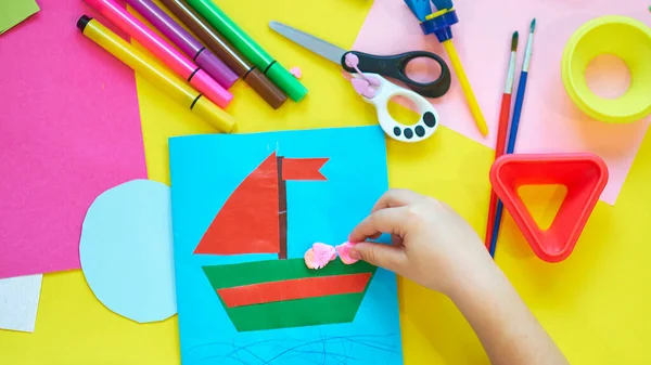 Child sculpts plasticine crafts with his hands. Top view. fine motor skills, preparing hands for writing. — Stock Photo, Image