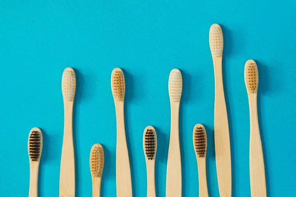 Wooden toothbrushes on a blue background. zero waste concept. dental care without platysik. — Stock Photo, Image