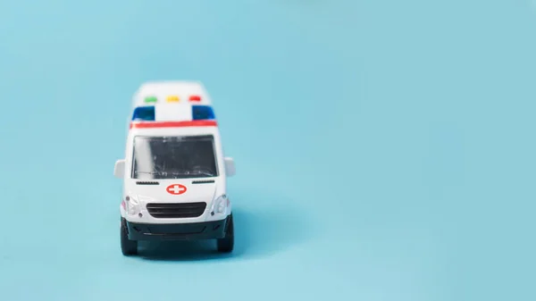 Primer plano de la ambulancia de juguete sobre fondo azul . —  Fotos de Stock