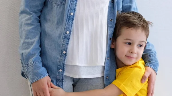 Ragazzino triste, ragazzo, abbracciare sua madre a casa, copiare spazio. Concetto familiare — Foto Stock