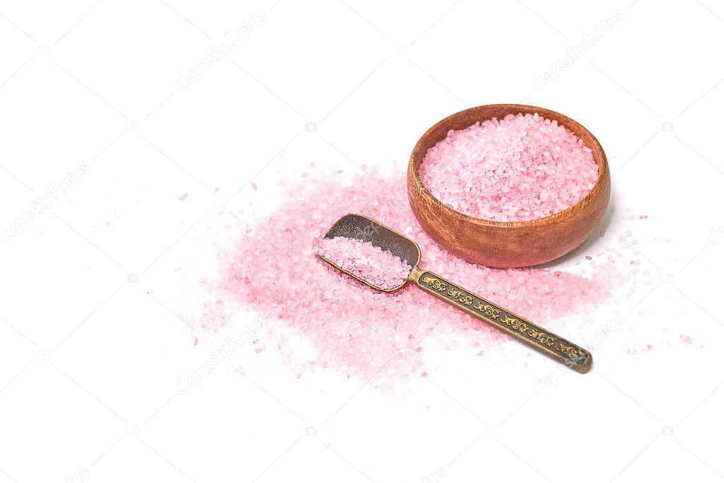 Pink salt isolated in scoop on white background. selective focus or blurry.