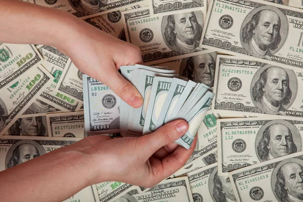 Cash in hand. Profit, savings. Stack of dollars. a person who is counting money against the background of money, success, motivation, financial flows, wealth. Buy dollars, dollars manually Royalty Free Stock Images