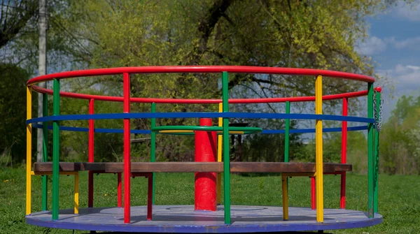 Children's iron carousel. Children's playground. Swing, carousel and slide — Stock Photo, Image