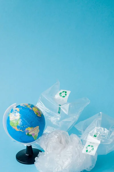 Ban plastic pollution. Globe and plastic bag out of the globe. C