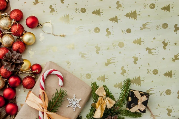 Christmas gift box, food decor and fir tree branch on wooden table. Top view with copy space