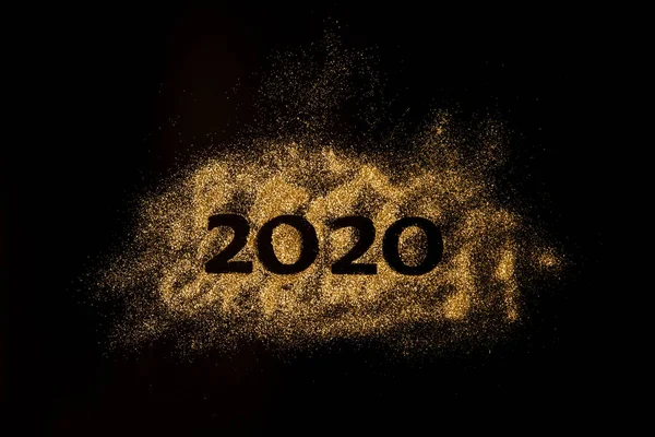 Happy New Year 2020. Creative Collage of numbers two and zero made up the year 2020. Beautiful sparkling Golden number 2020 on black background for design.