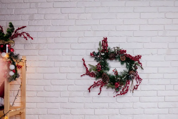 Christmas wreath on white brick wall background. Christmas holid