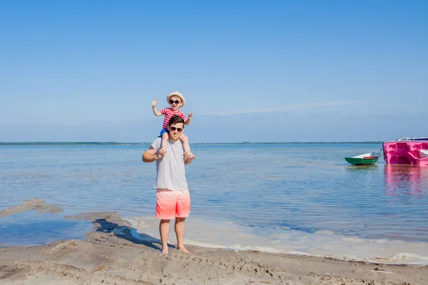 Far och son som spelar på stranden på dagarna — Stockfoto
