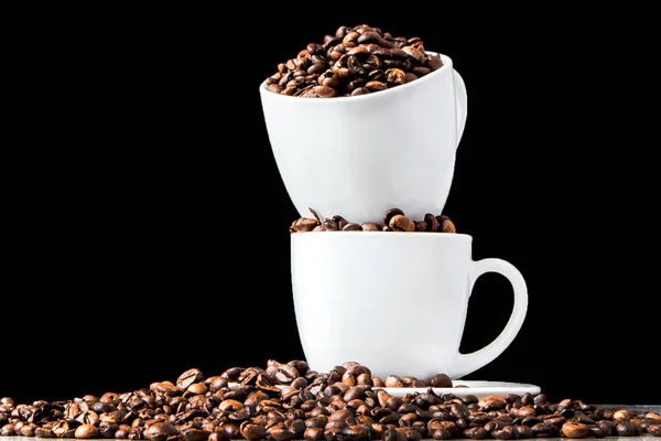 Black coffee in white cup and coffee beans on black background. — Stock Photo, Image