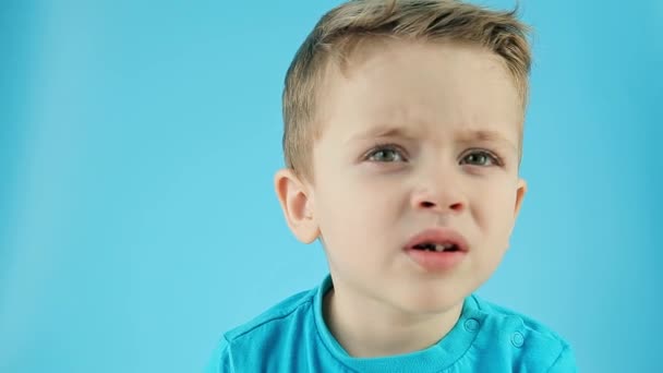 Boy Picking His Nose Close Blue Background Points His Fingers — Stock Video