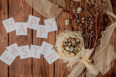 Flat lay composition of quail eggs and card with text Happy East