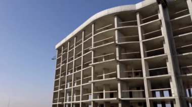 Bir şehirde inşaat halindeki yüksek apartmanın beton çerçevesinin havadan görünüşü