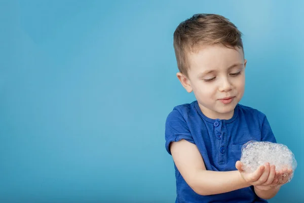 Child showing his hands with soap lather, cleaning and hygiene concept.Cleaning your hands frequently with water and soap will help prevent an epidemic from pandemic virus.