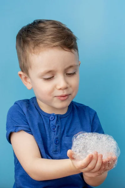 Child showing his hands with soap lather, cleaning and hygiene concept.Cleaning your hands frequently with water and soap will help prevent an epidemic from pandemic virus.
