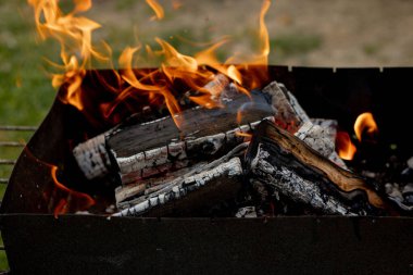Barbekü ızgarasında odun yakıyorum. Sıcak bahar ya da yaz akşamları ızgara ateşinin yanında.