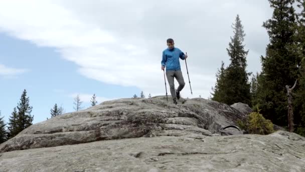 Young Carefree Boy Climbing Solid Huge Rocks Using Poles Make — Stock Video