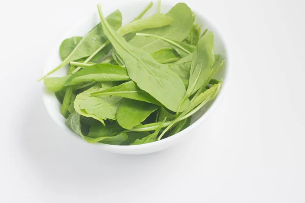 Arugula Leaves into a bowl — Stock Photo, Image