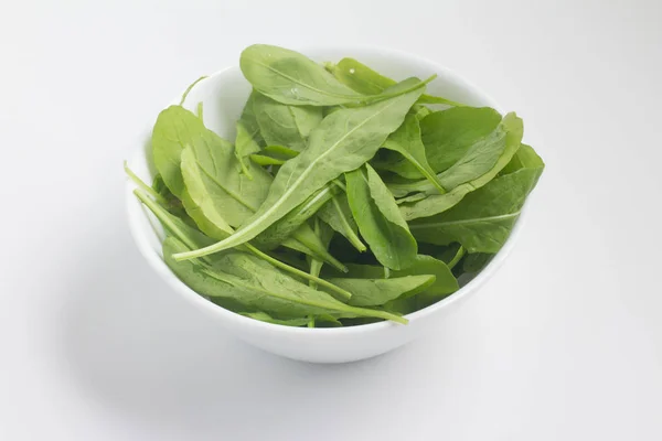 Arugula Leaves into a bowl — Stock Photo, Image