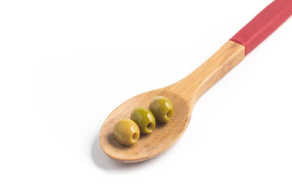 Green Olives into a spoon — Stock Photo, Image