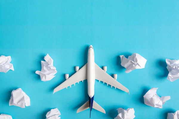 Airplane model flying among paper clouds, Traveling concept