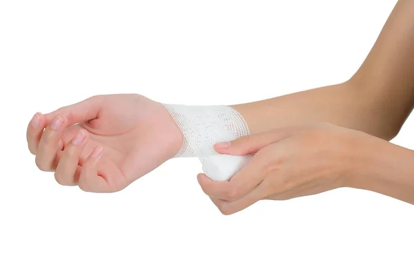 Woman bandaging  and first aid her beautiful Healthy wrist in pain area, Isolated on white background. — Stock Photo, Image