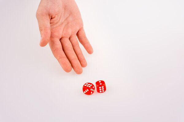 Hand holding red dice