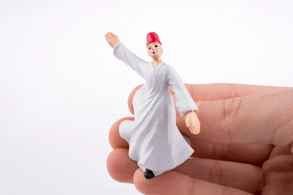 Hand hält einen Sufi-Derwisch — Stockfoto