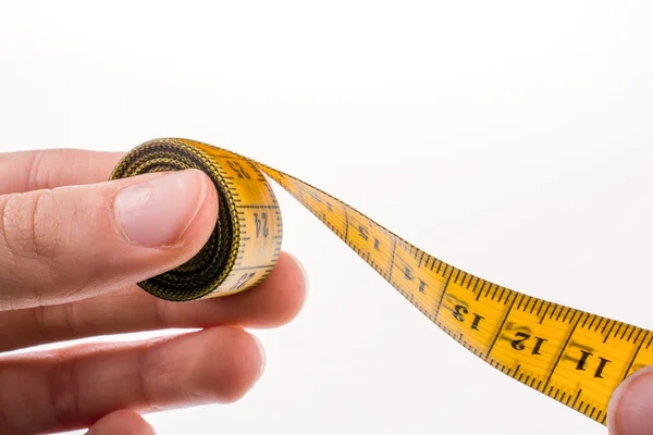 Measuring tape in hand — Stock Photo, Image