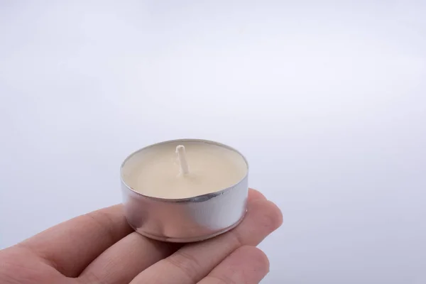 Barevné malé svíčkou v ruce — Stock fotografie