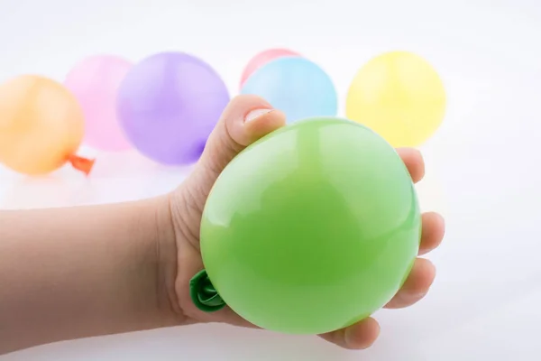 Hand holding a Colorful small balloon in hand — Stock Photo, Image