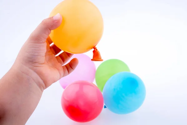 Hand holding a Colorful small balloon in hand — Stock Photo, Image