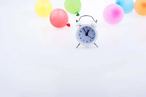 Väckarklocka med ballonger runt — Stockfoto