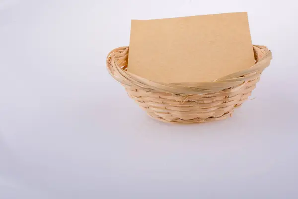 Blank note paper in a basket made of straw