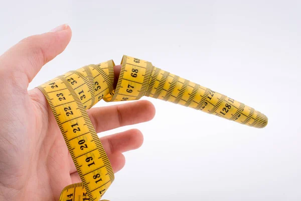 Yellow color measuring tape in hand — Stock Photo, Image