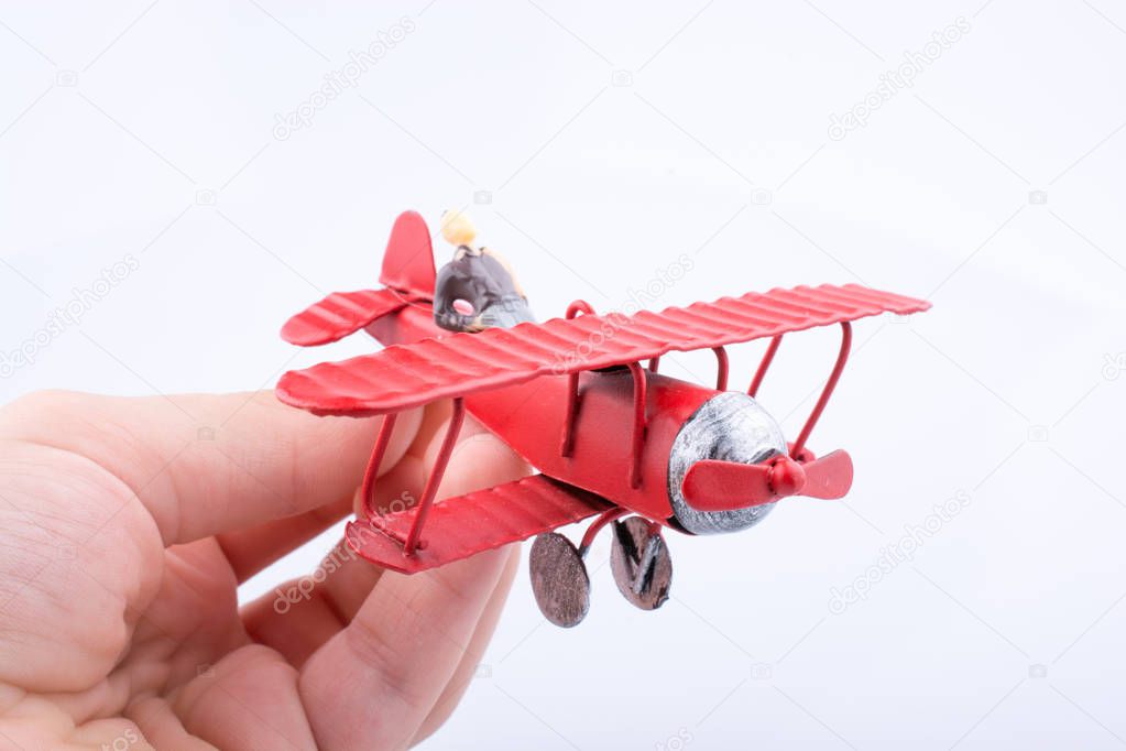 Little metal model airplane in child hand