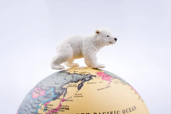 Polar bear on the top of the globe — Stock Photo, Image