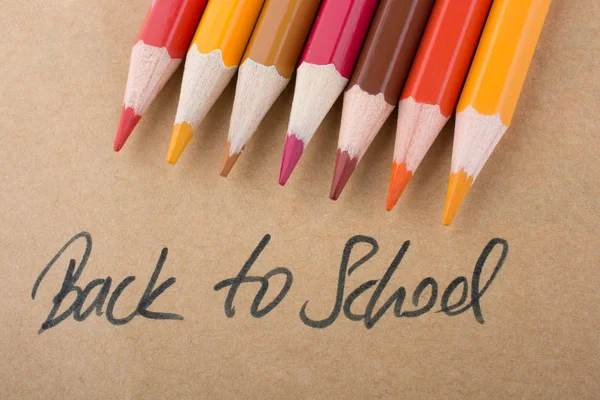 Кольорові олівці і назад до назви школи — стокове фото