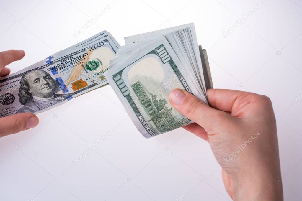 Human hand holding American dollar banknotes on white background