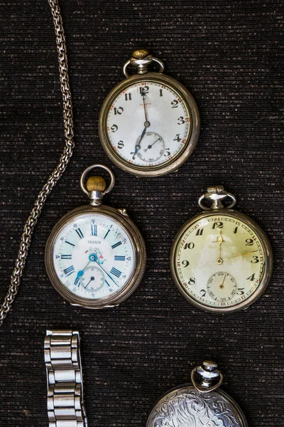 Retro style classic pocket watches on a piece of fabric