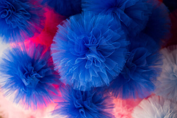 Set of different colours and shapes of pompoms in an bazaar