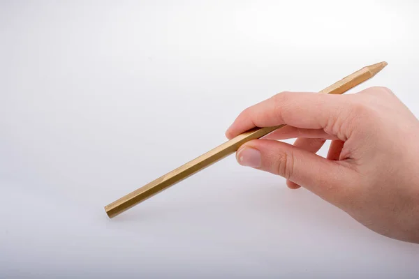 Hand met een gouden kleur potlood in de hand — Stockfoto