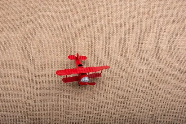 Játék repülőgép vászon vászon háttér — Stock Fotó