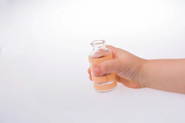 Pequeña botella de vidrio vacía en la mano —  Fotos de Stock
