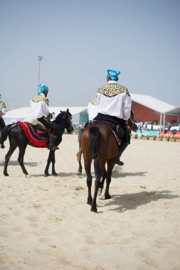 Atlılar at sırtında etnik kıyafetleriyle geziyorlar.