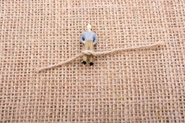 Heykelcik adam ayak üzerinde bir ip ile