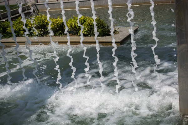 公園内のプールで輝く水を噴出する噴水 — ストック写真