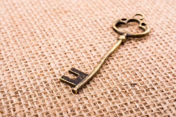 Retro styled key on a linen canvas