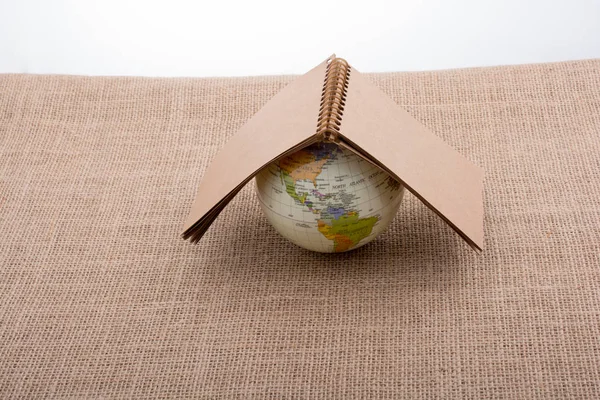 Globe placed on canvas background — Stock Photo, Image
